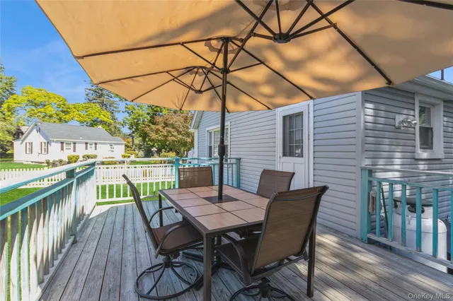 a view of a deck with furniture and barbeque grill