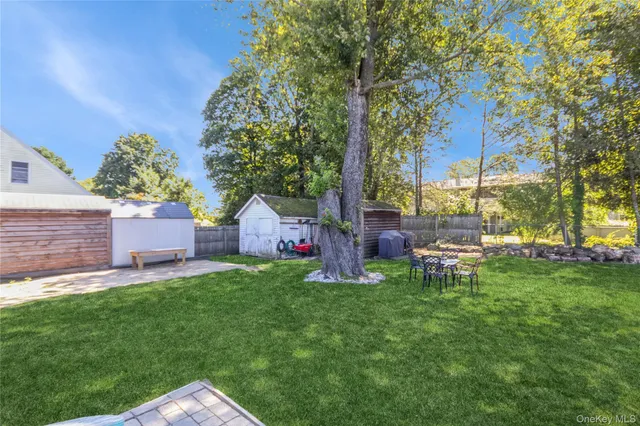 a view of backyard with a garden and trees