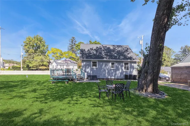 a view of a chairs in a backyard of a house