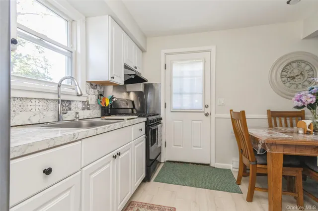 a kitchen with a sink cabinets and window