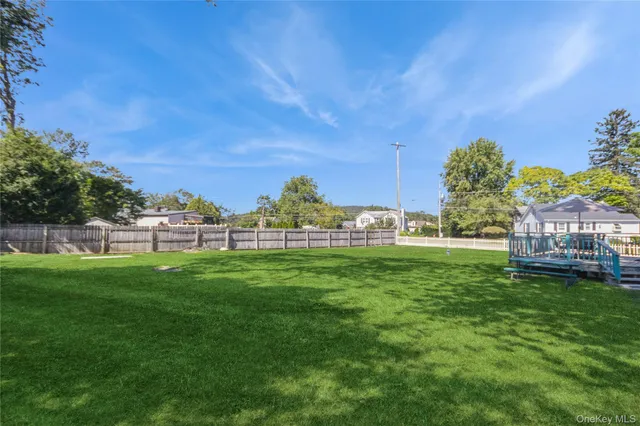 a view of a field of grass and trees