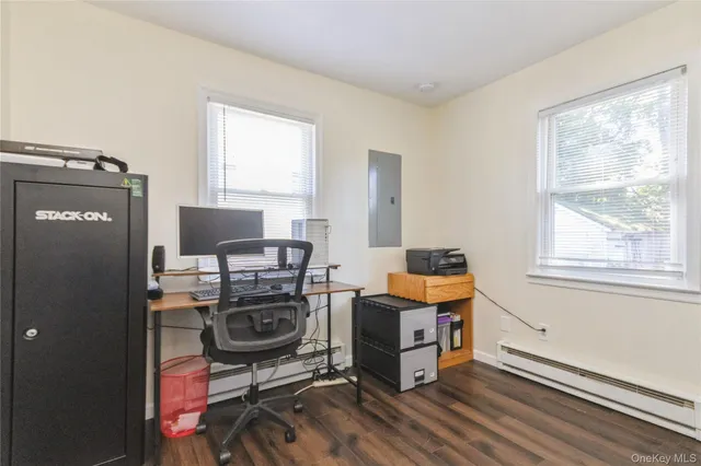 a view of a workspace with furniture and a window