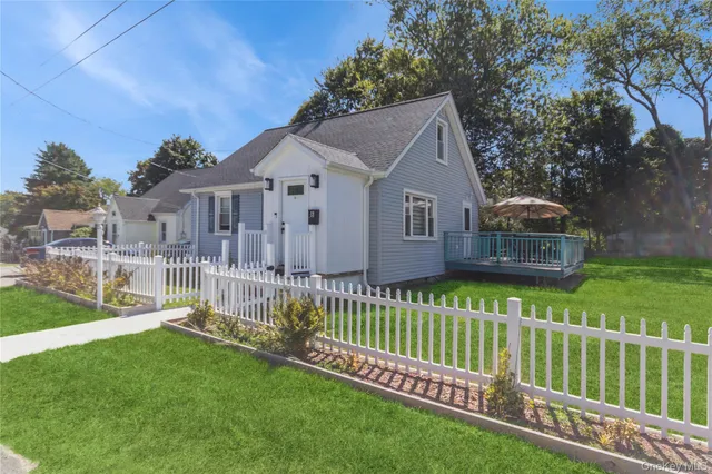 a front view of a house with a garden and deck