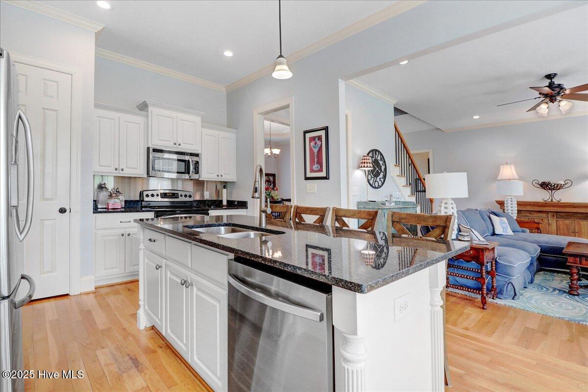 6886 Williams Place Sims, NC 27880 - Photo 13 of 31 Kitchen with large pantry, granite countertops and stainless appliances. Open to the living room - great for entertaining.