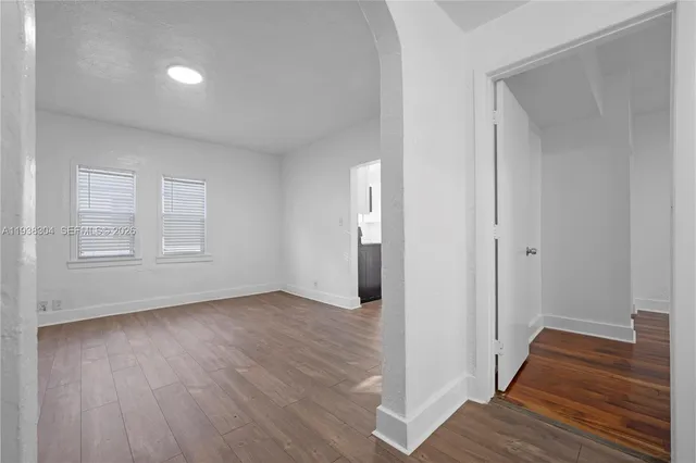 a view of a room with wooden floor and window