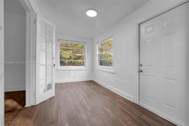 wooden floor in an empty room with a window