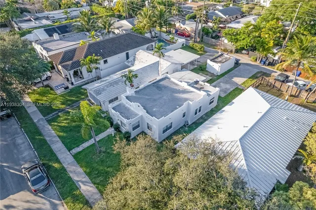 an aerial view of a house with garden space and street view