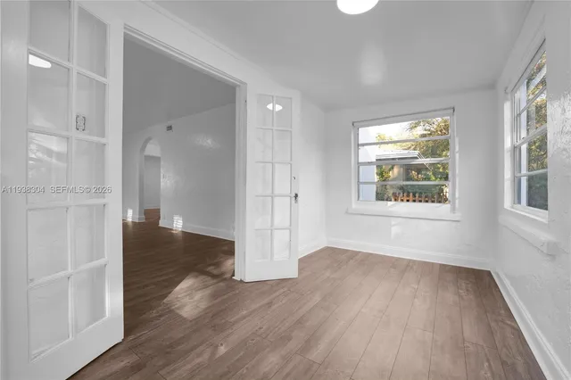 wooden floor in an empty room with a window