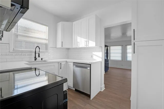 a kitchen with a sink cabinets and stainless steel appliances