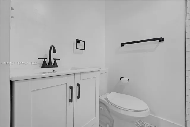 a bathroom with a toilet sink and vanity