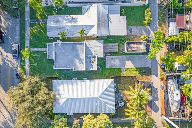an aerial view of a house with swimming pool garden and patio