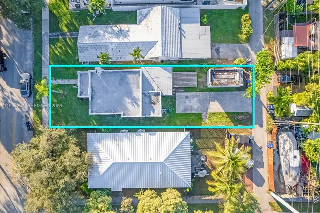 a aerial view of a chairs and table in the backyard