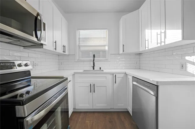 a kitchen with a sink stove and cabinets