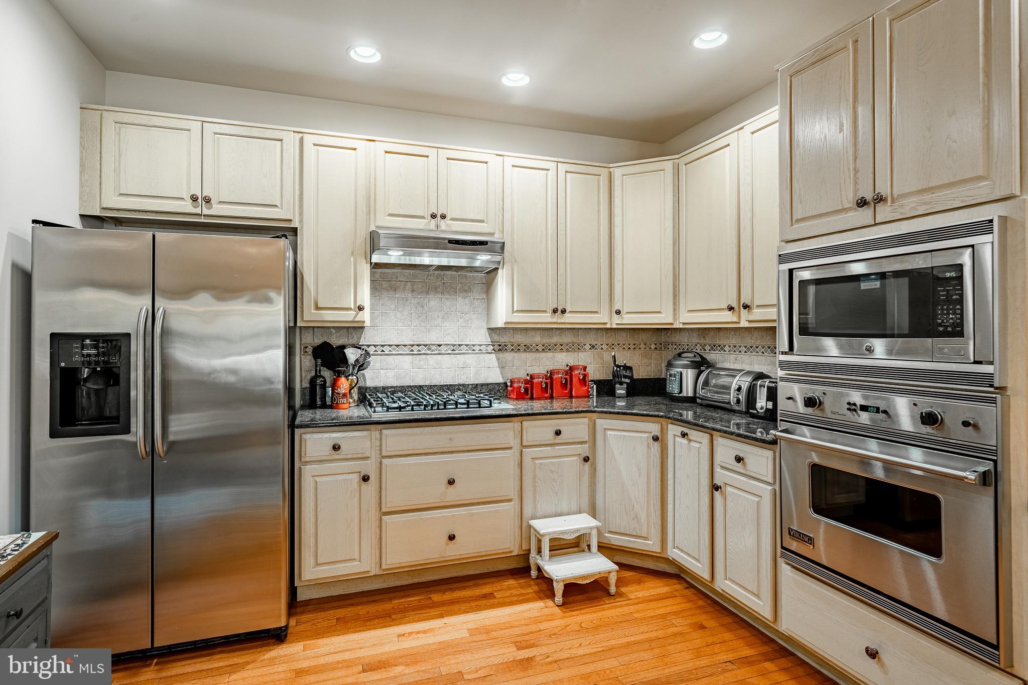 2 River Road Philadelphia, PA 19128 - Photo 17 of 46 a kitchen with stainless steel appliances granite countertop a stove a refrigerator and a microwave