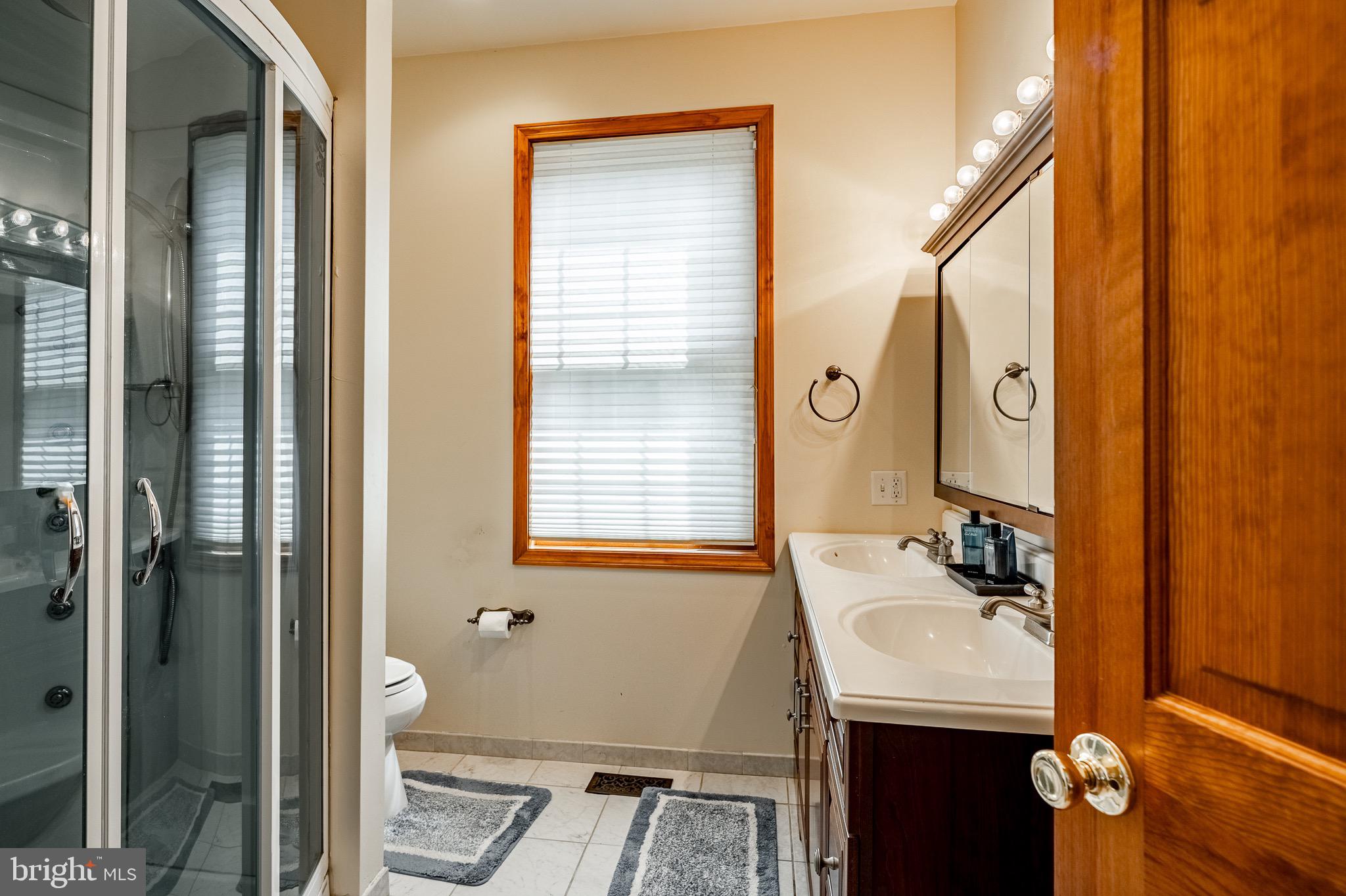 2 River Road Philadelphia, PA 19128 - Photo 21 of 46 a bathroom with a sink and a mirror
