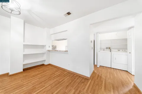 a view of an empty room with a fireplace and a window