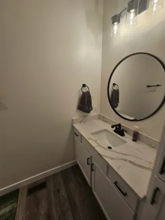 a bathroom with a sink mirror vanity and toilet