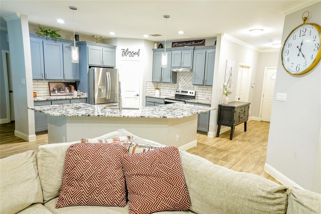 1012 Bowers Road Seagoville, TX 75159 - Photo 14 of 26 a living room with kitchen island granite countertop furniture and a kitchen