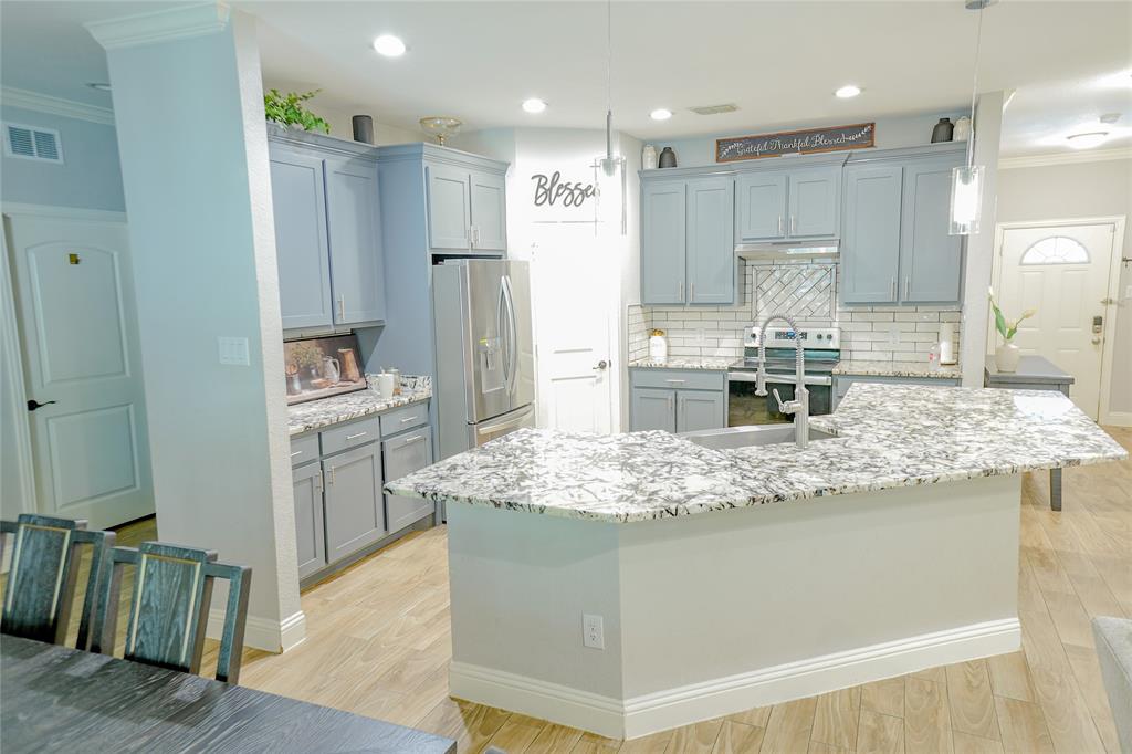 1012 Bowers Road Seagoville, TX 75159 - Photo 15 of 26 a kitchen with kitchen island counter top and refrigerator