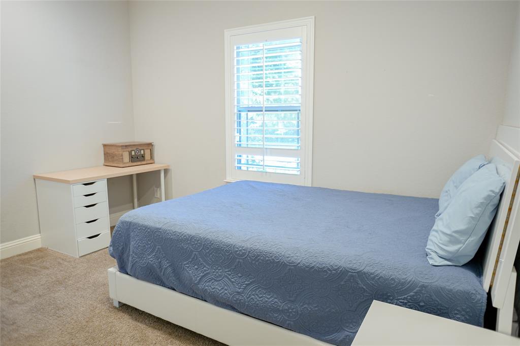 1012 Bowers Road Seagoville, TX 75159 - Photo 16 of 26 a bedroom with a bed and a chair