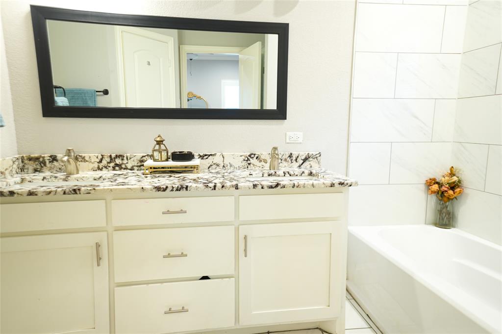 1012 Bowers Road Seagoville, TX 75159 - Photo 17 of 26 a bathroom with a sink vanity and mirror