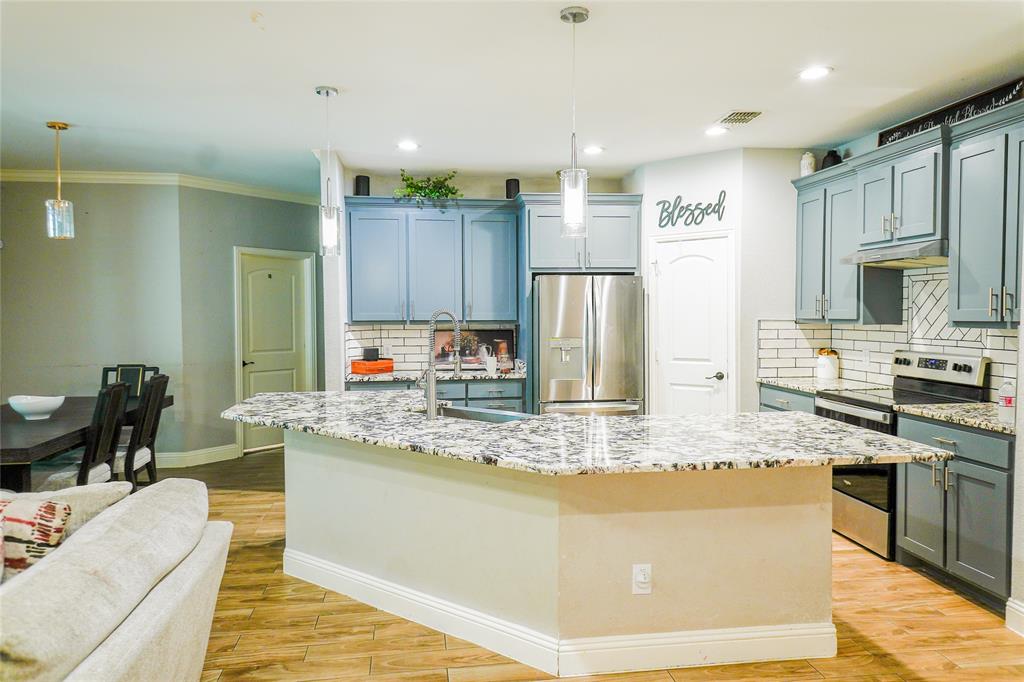 1012 Bowers Road Seagoville, TX 75159 - Photo 2 of 26 a kitchen with stainless steel appliances granite countertop a stove a sink a refrigerator and a microwave