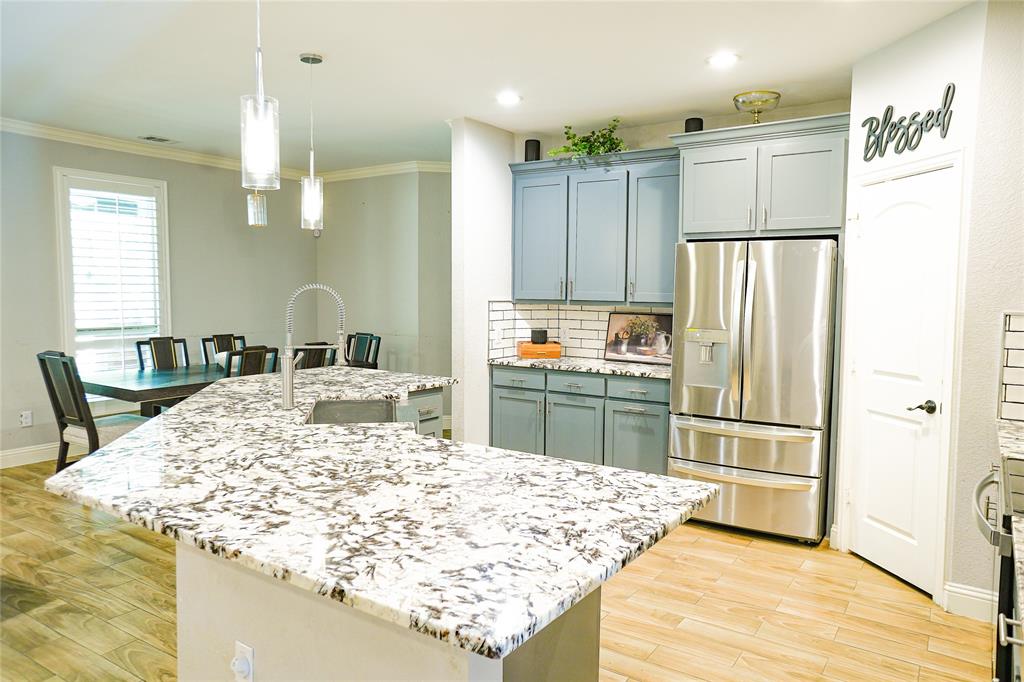 1012 Bowers Road Seagoville, TX 75159 - Photo 8 of 26 a kitchen with kitchen island a refrigerator stove and sink