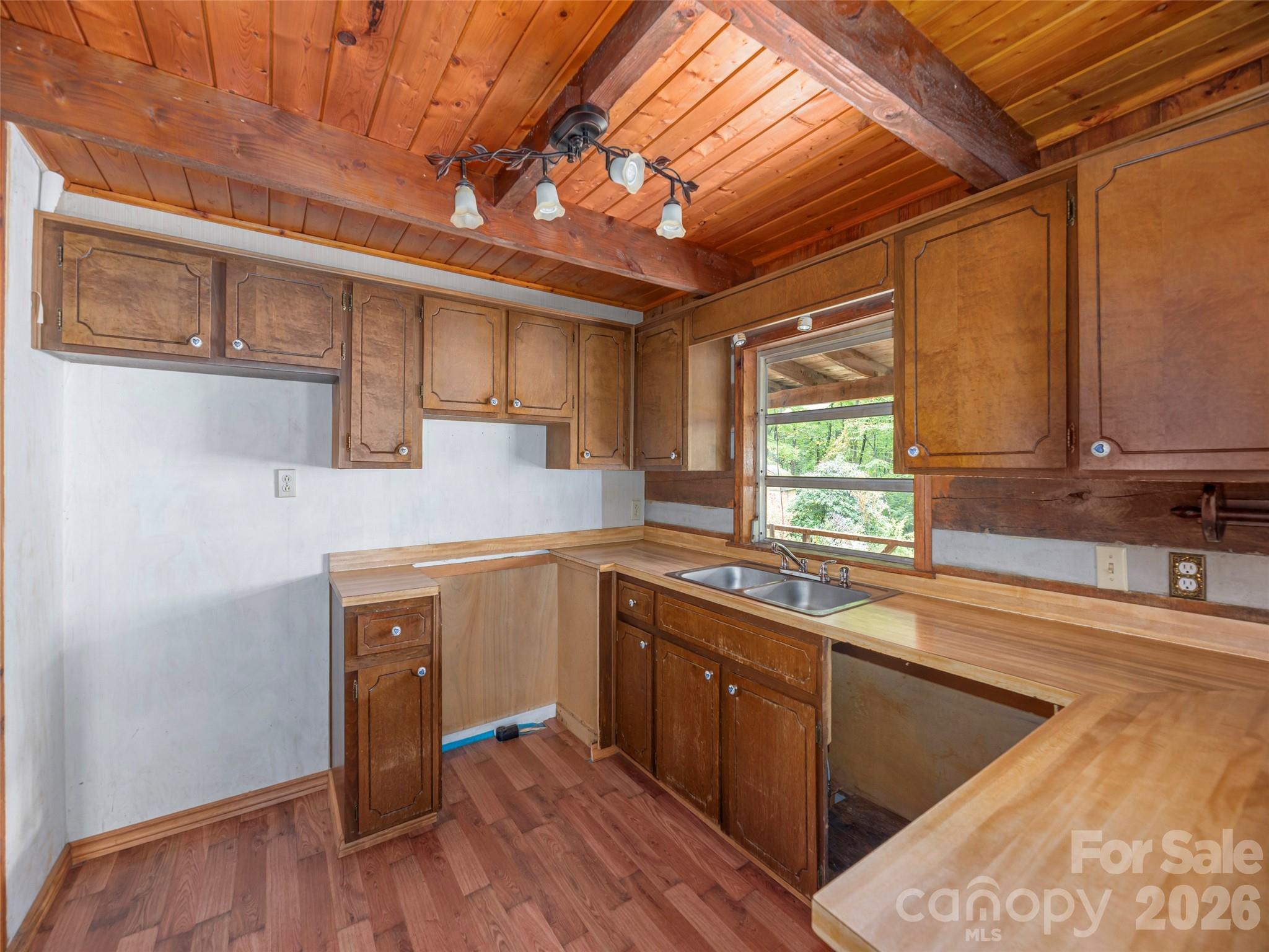 775 Chambers Cove Road Canton, NC 28716 - Photo 11 of 28 a kitchen with wooden cabinets and sink