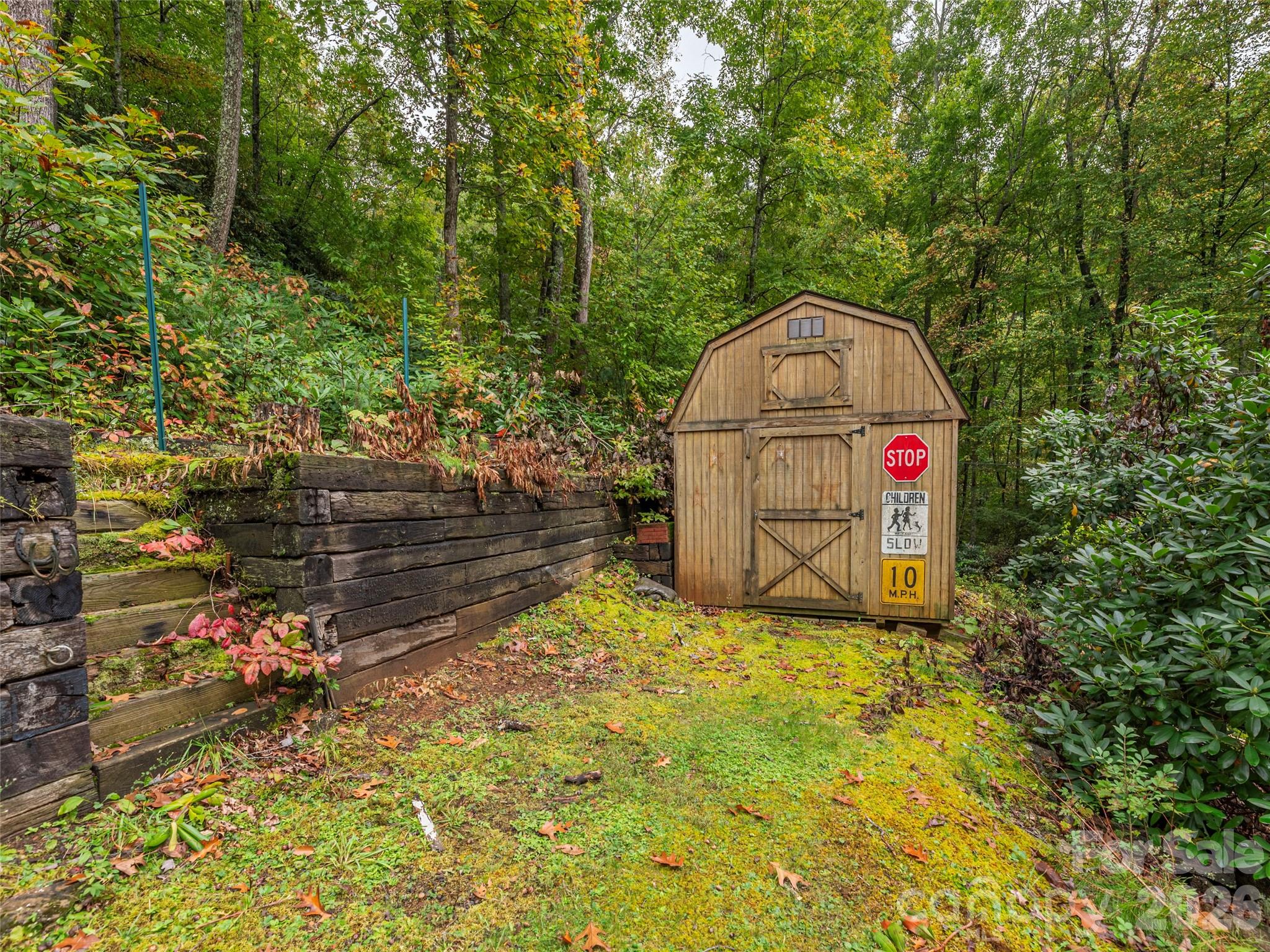 775 Chambers Cove Road Canton, NC 28716 - Photo 24 of 28 a sign that is sitting in the middle of a forest