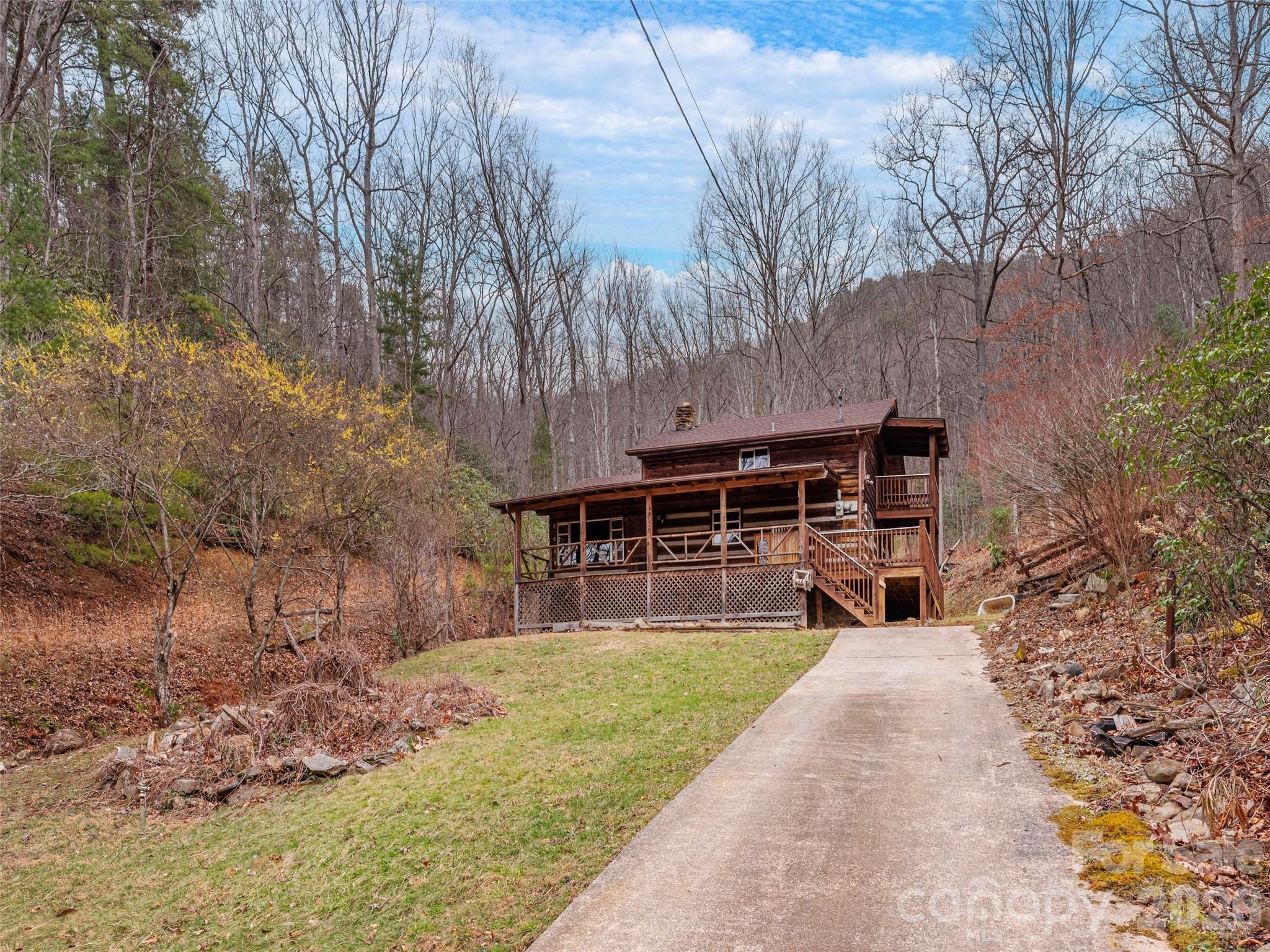 775 Chambers Cove Road Canton, NC 28716 - Photo 25 of 28 a view of a house with backyard and trees
