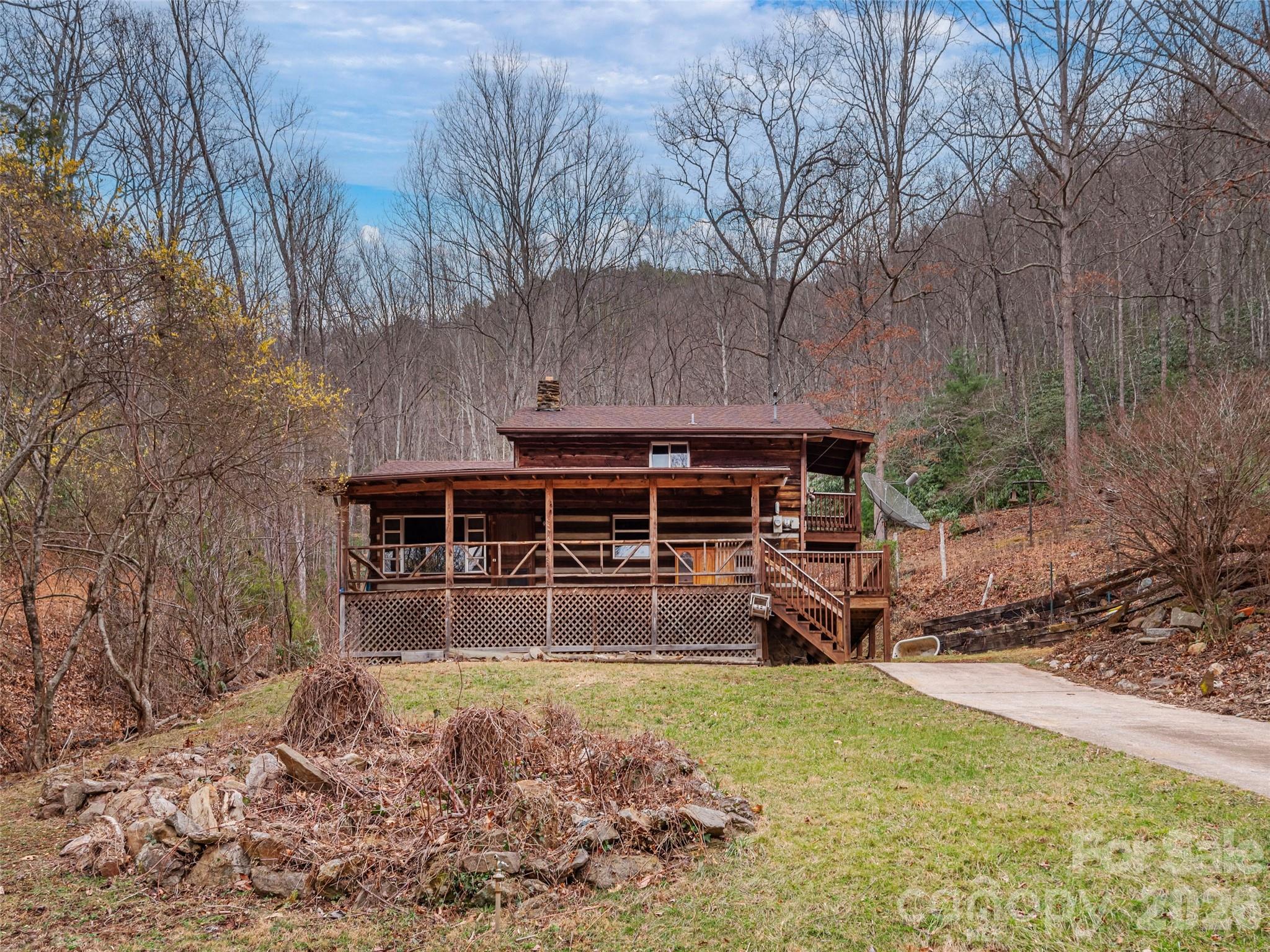 775 Chambers Cove Road Canton, NC 28716 - Photo 26 of 28 a view of a house with backyard and sitting area