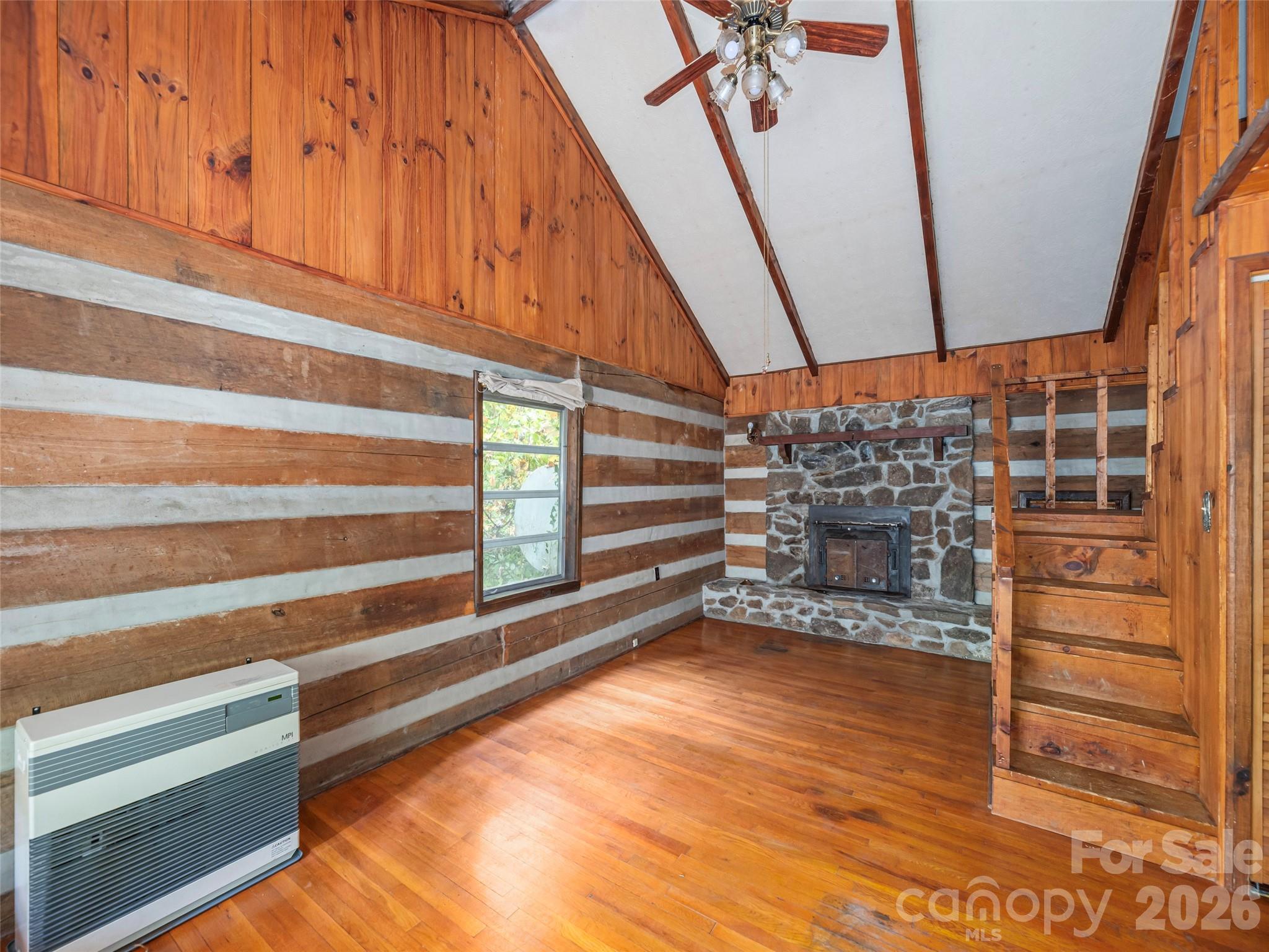 775 Chambers Cove Road Canton, NC 28716 - Photo 7 of 28 a view of an empty room with wooden floor and a window