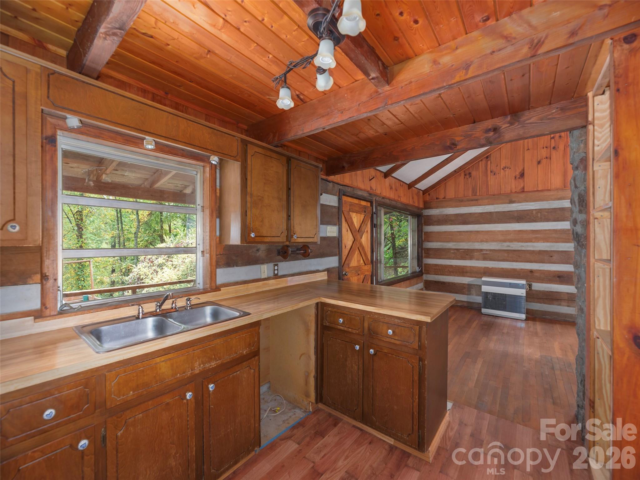 775 Chambers Cove Road Canton, NC 28716 - Photo 10 of 28 a kitchen with sink a window and cabinets