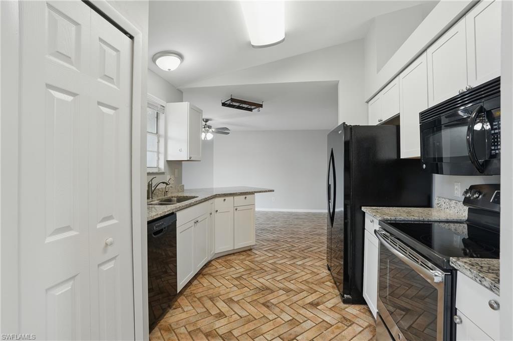 18210 Apple Road Fort Myers, FL 33967 - Photo 4 of 29 a kitchen with stainless steel appliances a refrigerator sink and stove