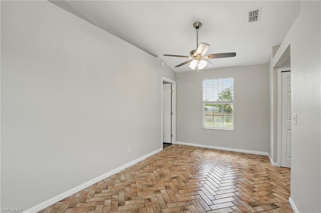 18210 Apple Road Fort Myers, FL 33967 - Photo 8 of 29 a view of a room with a ceiling fan and a window