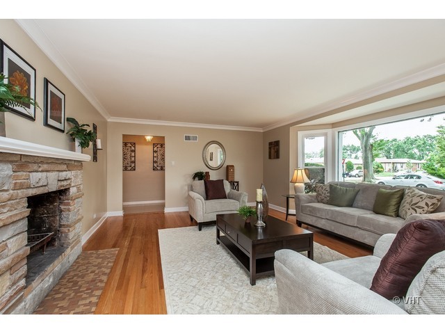 8500 Springfield Avenue Skokie, IL 60076 - Photo 2 of 15 a living room with furniture a fireplace and a large window
