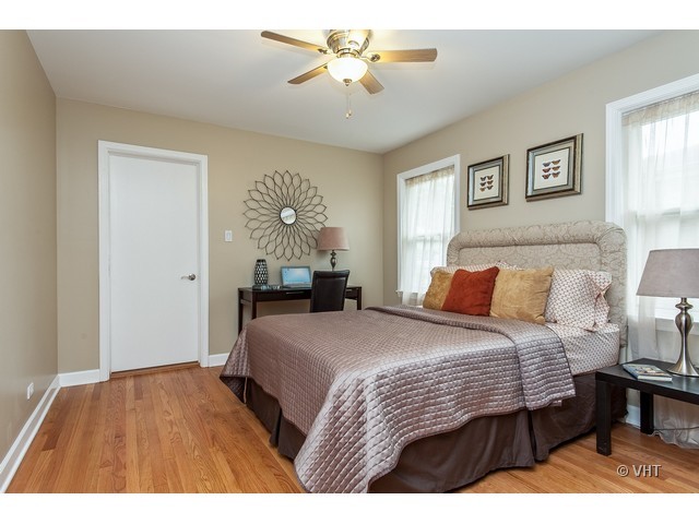8500 Springfield Avenue Skokie, IL 60076 - Photo 12 of 15 a bedroom with a bed and a chandelier
