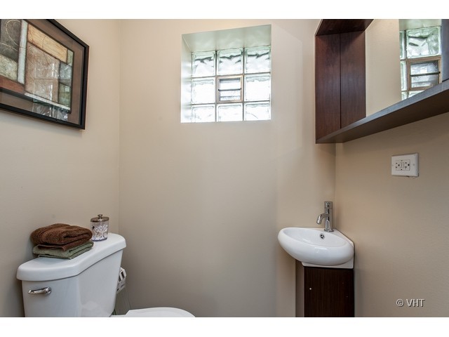 8500 Springfield Avenue Skokie, IL 60076 - Photo 15 of 15 a bathroom with a sink mirror and toilet