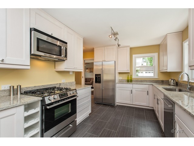 8500 Springfield Avenue Skokie, IL 60076 - Photo 4 of 15 a kitchen with stainless steel appliances a stove sink microwave and cabinets