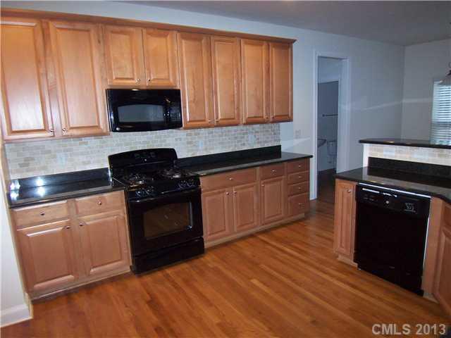 289 Lorraine Road Fort Mill, SC 29708 - Photo 8 of 16 a kitchen with granite countertop a stove top oven and cabinets