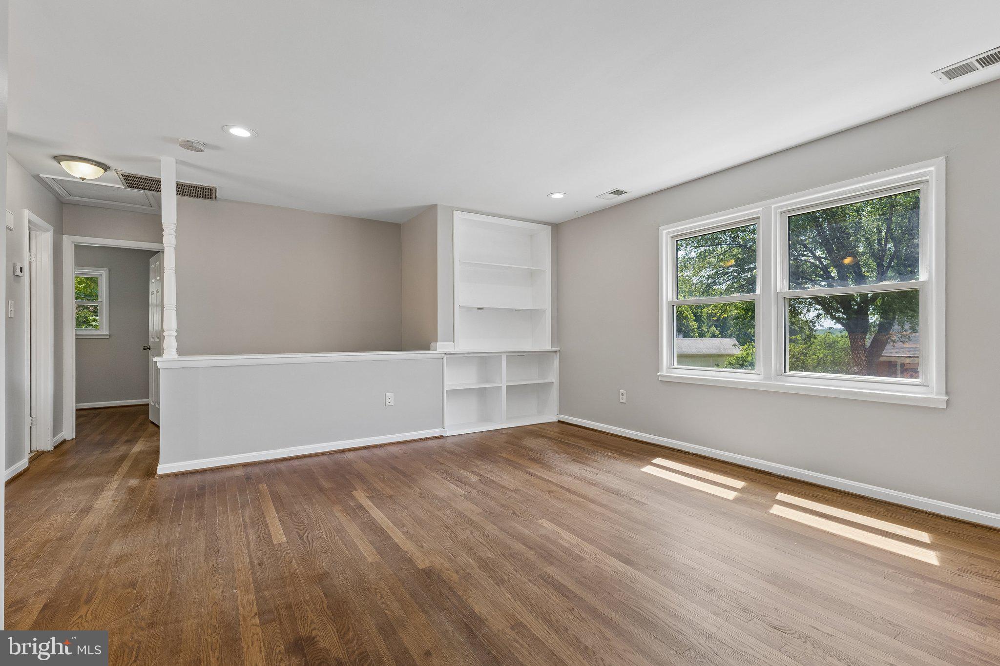 14197 Fullerton Road Woodbridge, VA 22193 - Photo 14 of 23 an empty room with wooden floor and windows