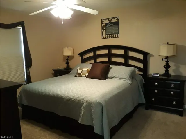 a bedroom with a bed and a mirror