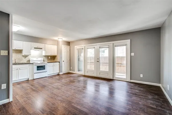 a view of large kitchen with wooden floor and electronic appliances
