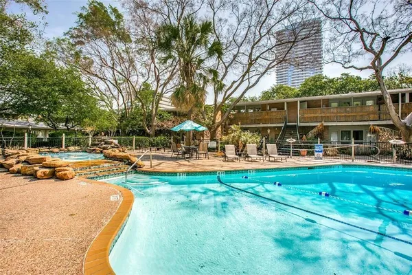 a swimming pool with outdoor seating and yard