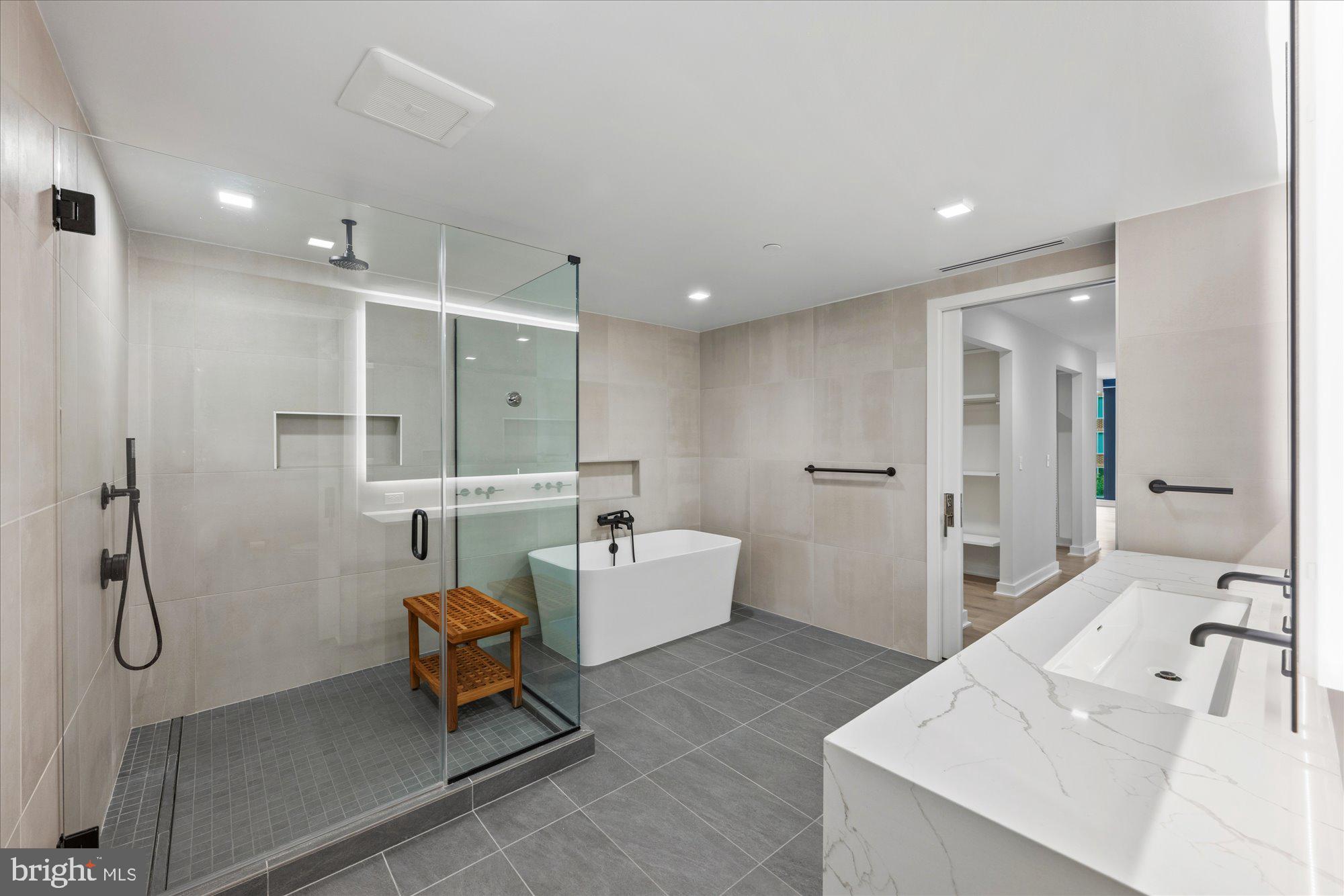 1336 8th Street Northwest, Unit TH5 Washington, DC 20001 - Photo 12 of 32 a bathroom with a tub sink a toilet and mirror