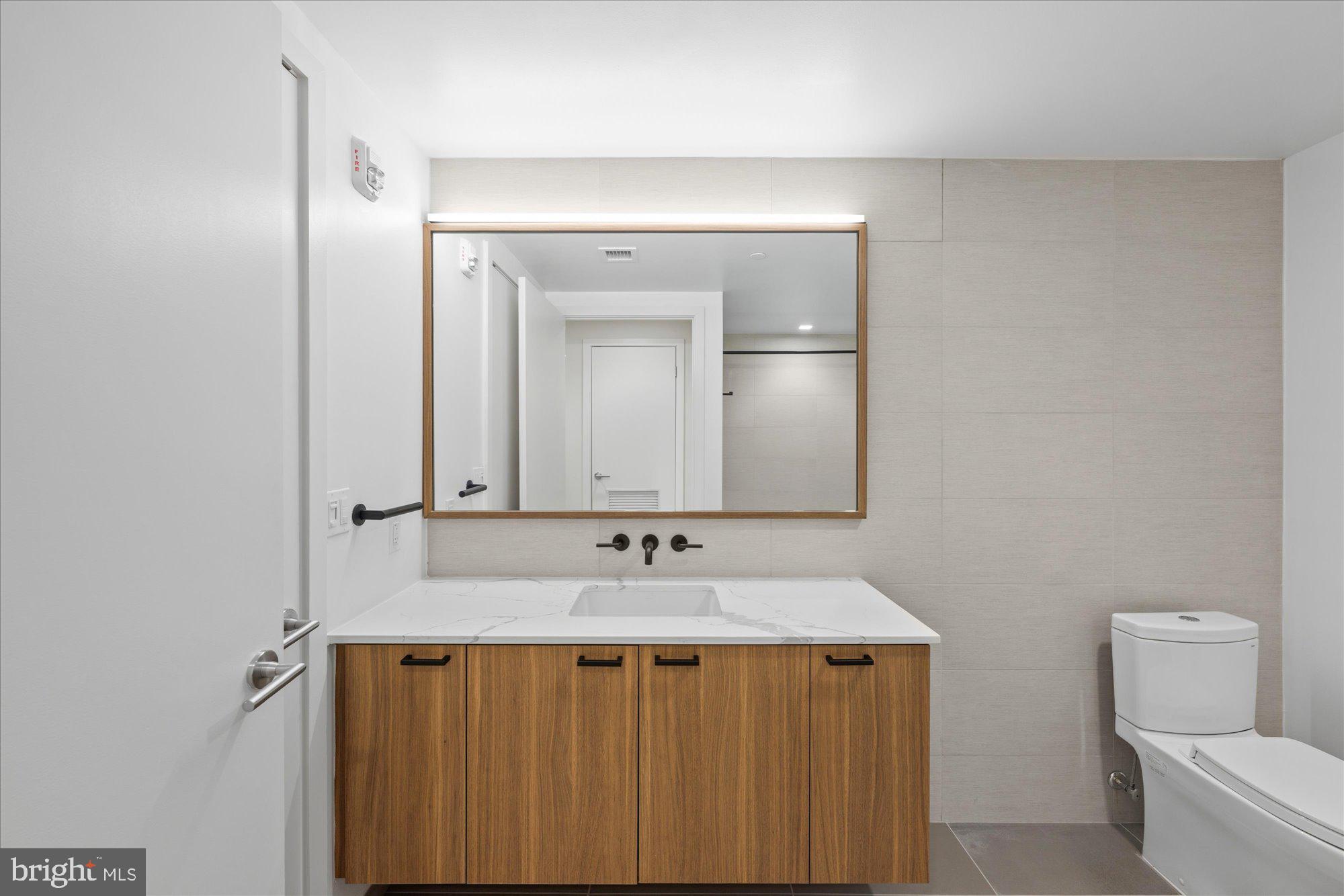 1336 8th Street Northwest, Unit TH5 Washington, DC 20001 - Photo 15 of 32 a bathroom with a sink and a mirror