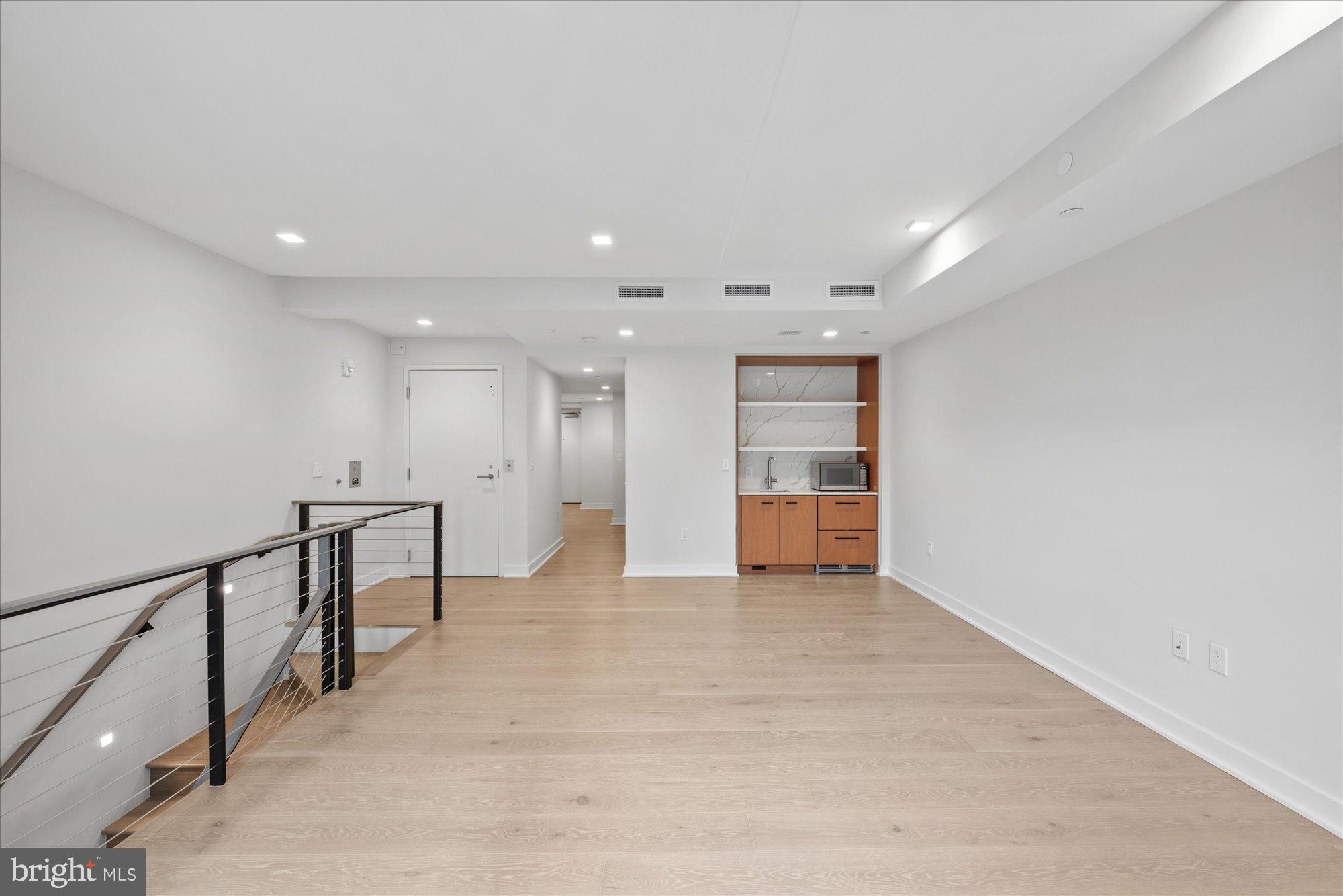 1336 8th Street Northwest, Unit TH5 Washington, DC 20001 - Photo 16 of 32 a view of an empty room with wooden floor