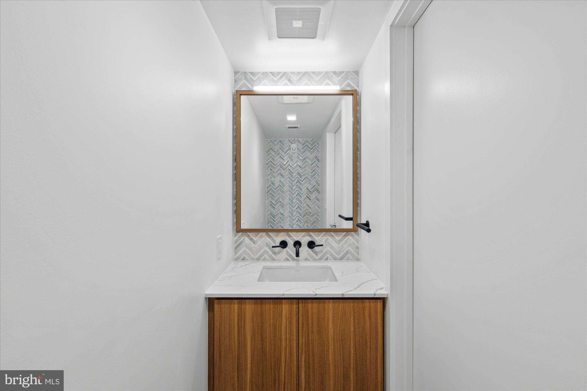 1336 8th Street Northwest, Unit TH5 Washington, DC 20001 - Photo 18 of 32 a bathroom with a sink and a mirror