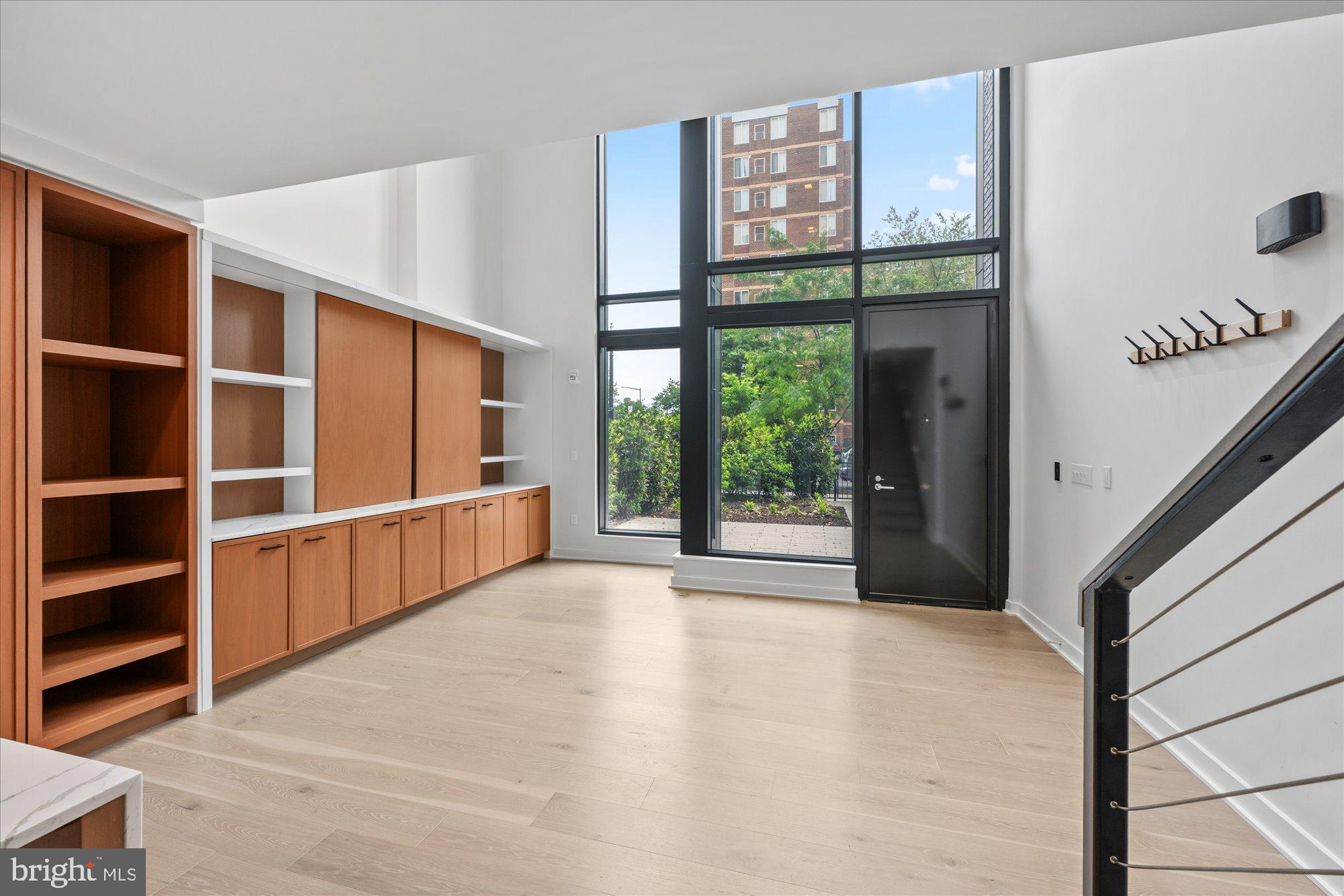 1336 8th Street Northwest, Unit TH5 Washington, DC 20001 - Photo 6 of 32 a view of an empty room with a window and a kitchen view