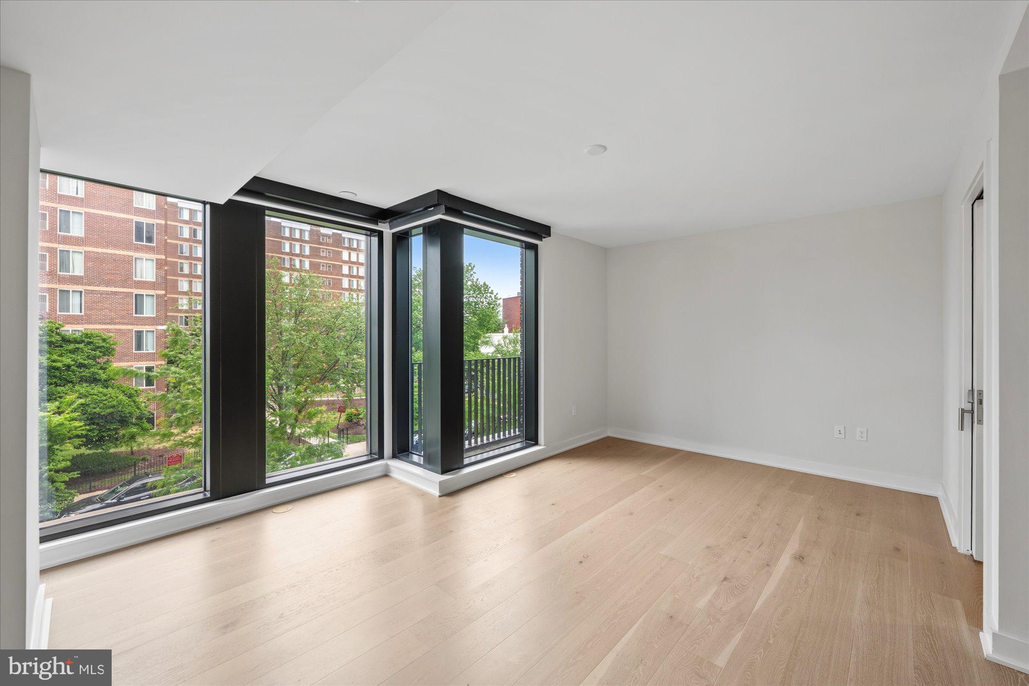 1336 8th Street Northwest, Unit TH5 Washington, DC 20001 - Photo 10 of 32 a view of an empty room with wooden floor and a window